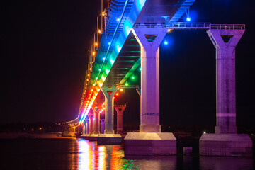 Low angle view of colourful bridge illuminated with different color lights at the night. Bridge...