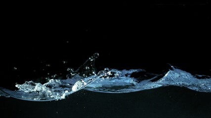 Super slow motion of waving water isolated on black background. Filmed on high speed cinema camera, 1000 fps.