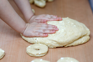 Traditional pastries. Homemade donuts. Photo 2: children's hands knead a baking dough with cottage cheese.
