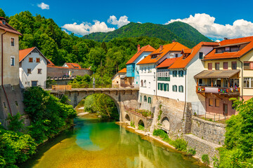 Fototapeta na wymiar Cityscape of Škofja Loka, Slovenia. View of the Capuchin Bridge over the Selška Sora River in the old city center