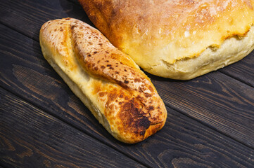 Bakeds loafs of Ukrainian national bread on a black vintage table. Traditional homemade baked goods