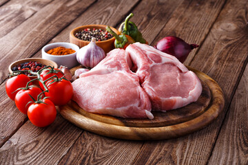 fresh raw new-york steak on wooden Board on wooden background with salt and pepper in a rustic style.