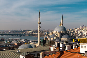Fototapeta na wymiar Eminonu Halic Port, New Mosque - Valide Sultan Mosque and Golden Horn Metro Bridge in Istanbul Turkey