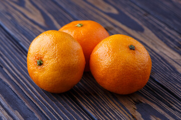 Mandarine orange or tangerine on wooden board