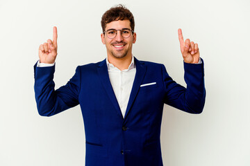 Young business caucasian man isolated on white background indicates with both fore fingers up showing a blank space.