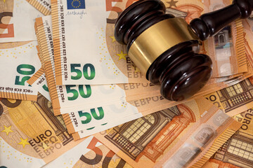 Judge hammer on 50 Euro banknotes background
