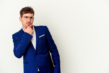 Young business caucasian man isolated on white background touching back of head, thinking and making a choice.