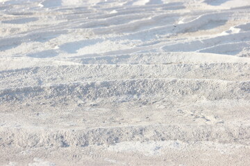 Fototapeta na wymiar Calcium travertine terraces in Pamukkale, Turkey. Limestone travertine surface.