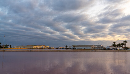 Fototapeta premium industrial salt manufacturing plant and salines at San Pedro del Pinatar in Murcia at sunset