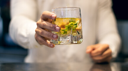 Barman serving mojito cocktail on glass. Concept for alcoholic drinks