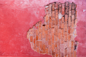 An old pink wall or brick wall that is cracked and off for the background. Pink brick wall background. Copy space for designs using old brick walls.