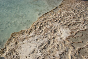Close up view of thermal springs of Pamukkale, Turkey. Close up of a travertine deposits on a rock.