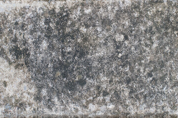 Dramatic dark grey and white natural stone, lightly textured surface.  For use as a background, overlay or wallpaper.