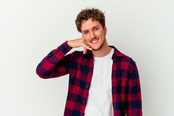 Fototapeta premium Young caucasian man isolated on white background showing a mobile phone call gesture with fingers.