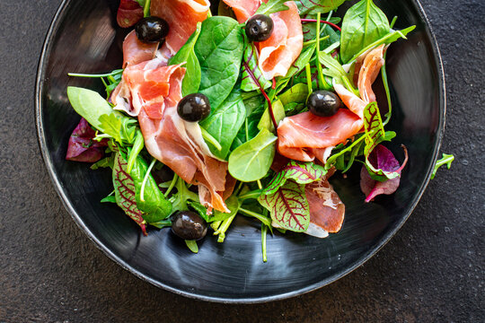 salad meat jamon prosciutto green leaves mix lettuce olives vegetables snack healthy meal top view copy space for text food background rustic image keto or paleo diet