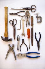 Vertical shot  of vintage metalwork tools isolated on a white background