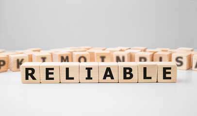 Word RELIABLE made with wood building blocks