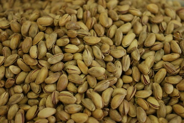 A pile of pistachios close up. A heap of pistachio nuts close up.
