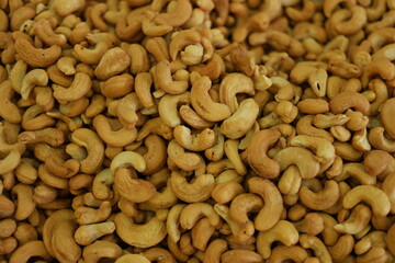 Cashew nuts close up. Organic golden cashew nuts background. Healthy snack concept.