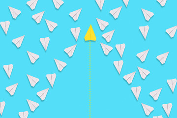 A yellow paper airplane flies confidently among the white planes in search of a new solution. Blue background. Flat lay. The concept of success and creativity