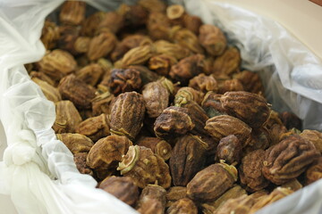 Box with dried brown figs close up. Dried fruits at market store. Healthy snack concept.