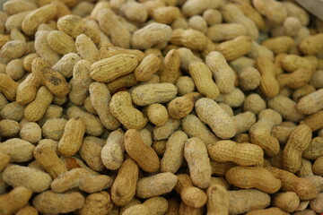 Heap of peanuts in shells close up. Peanuts background. Food concept.
