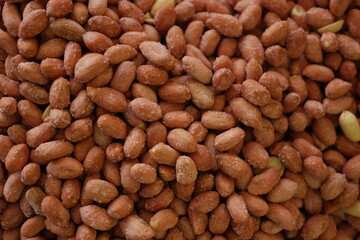 Pile of salted peanuts. Heap of roasted peanuts close up.