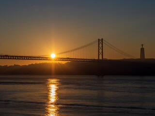 View over the Tagus River during sunrise and 25 de Abril Bridge