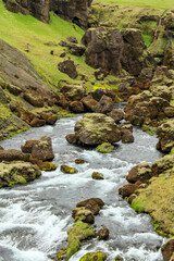 Impressive river with rocks laying inside at the Fimmvorduhals hiking trail