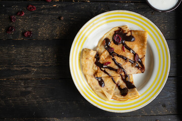thin pancakes crepes pour chocolate syrup white plate  flat cake snack healthy meal top view copy space for text food background rustic