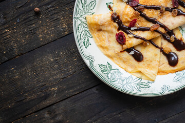 thin pancakes crepes pour chocolate syrup white plate  flat cake snack healthy meal top view copy space for text food background rustic
