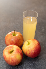 Apple juice from red apples fruits in a glass