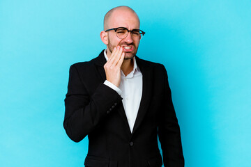 Young business caucasian bald man isolated on blue background having a strong teeth pain, molar ache.