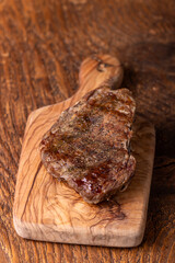 overview of a grilled steak on wood