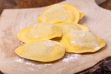 raw italian tortelli pasta with flour