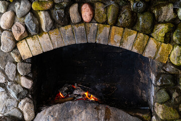 Wood logs are burning in the fireplace