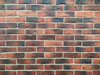 An old beautiful textured brick wall after restoration. Light concrete between bricks