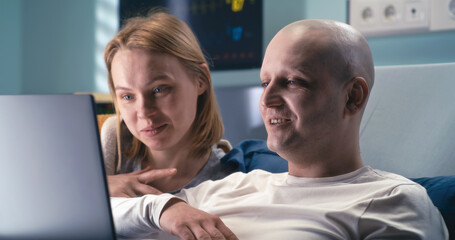 Obraz premium Happy man and woman making video call from clinic