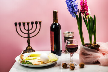 Passover celebration concept. bottle of wine, matzo, egg and lettuce
