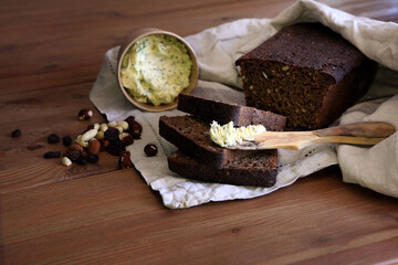 Fresh bread slice and cutting knife on rustic table