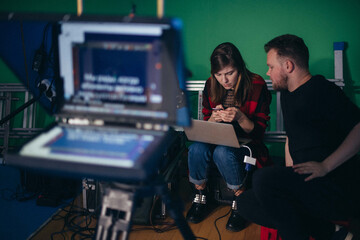 Director at work on the set.  Shooting shift, equipment and group. Modern photography technique.