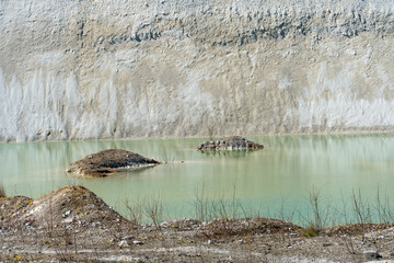 Large sand pit and lake. A flooded old abandoned quarry complex. Extraction of sand and stone for industrial applications.
