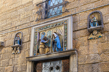 Small sculptures with a biblical theme above the entrance to the medieval building