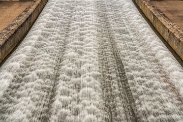 Water flowing down the dam of a reservoir
