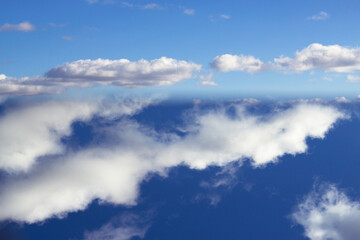unfocused textured background with different parts of blue sky with fluffy clouds - abstract nature drawing