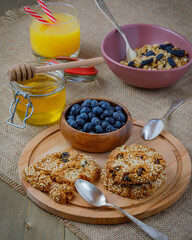 muesli with blueberries, oatmeal cookies with raisins and sesame, orange juice