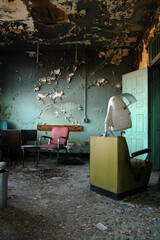 Fototapeta na wymiar Salon chairs inside an abandoned mental asylum