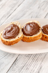 Slices of baguette with chocolate paste