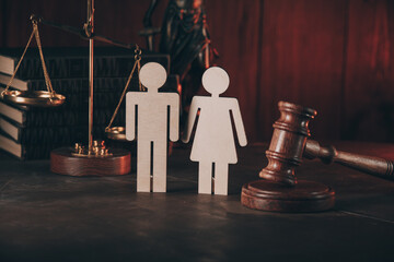 Figure in shape of people and gavel on wooden table. Family law concept.