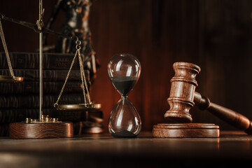 Judge gavel, scales and hourglass. Law and time concept.